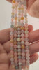 Video of strands of pastel morganite, heliodor and aquamarine spheres used for this tree, held in the hand