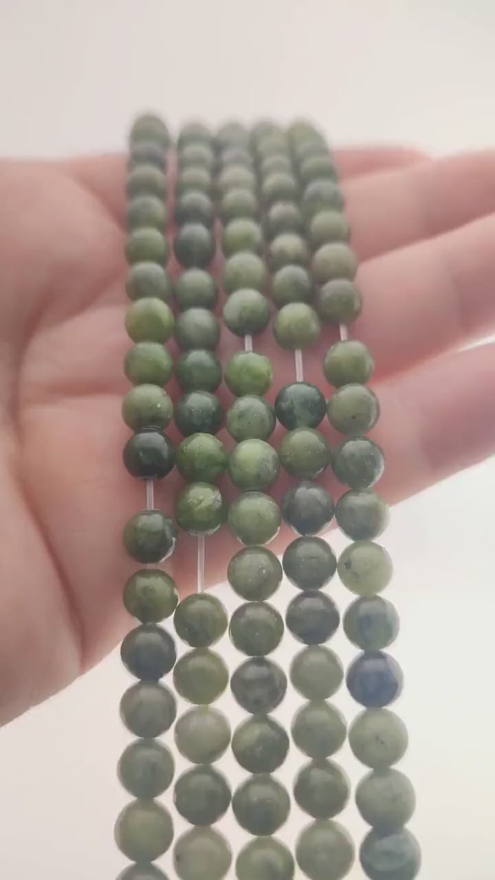 Video of strands of spinach green nephrite jade beads used for this tree, held in the hand