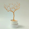 360° video of handmade gold jewelry tree with ceramic bowl and decorative white stones