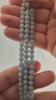 Video of strands of pale sky blue angelite spheres used for this tree, held in the hand