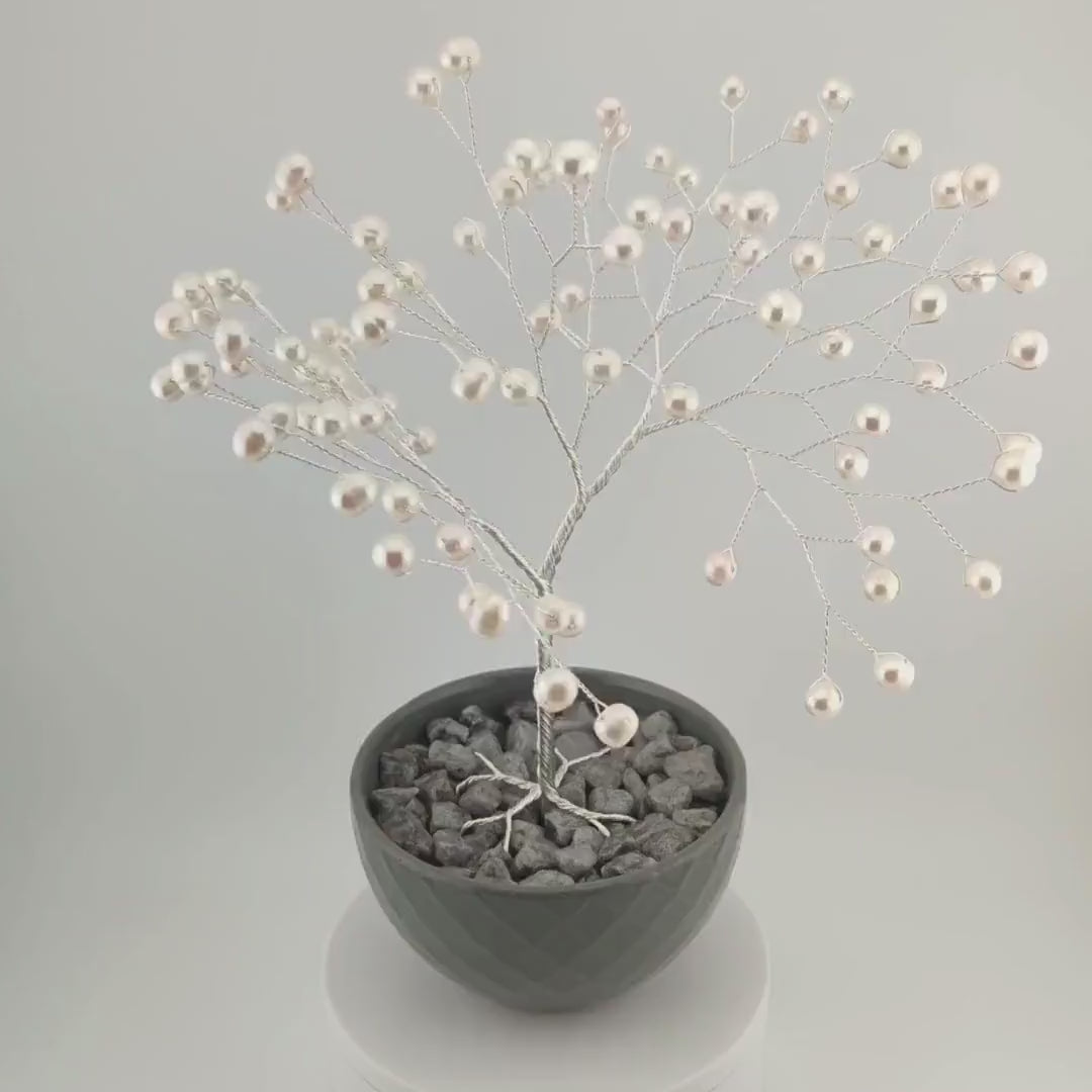 360° video of the silver wire tree of life with white freshwater pearls in a grey bowl