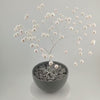 360° video of the silver wire tree of life with white freshwater pearls in a grey bowl