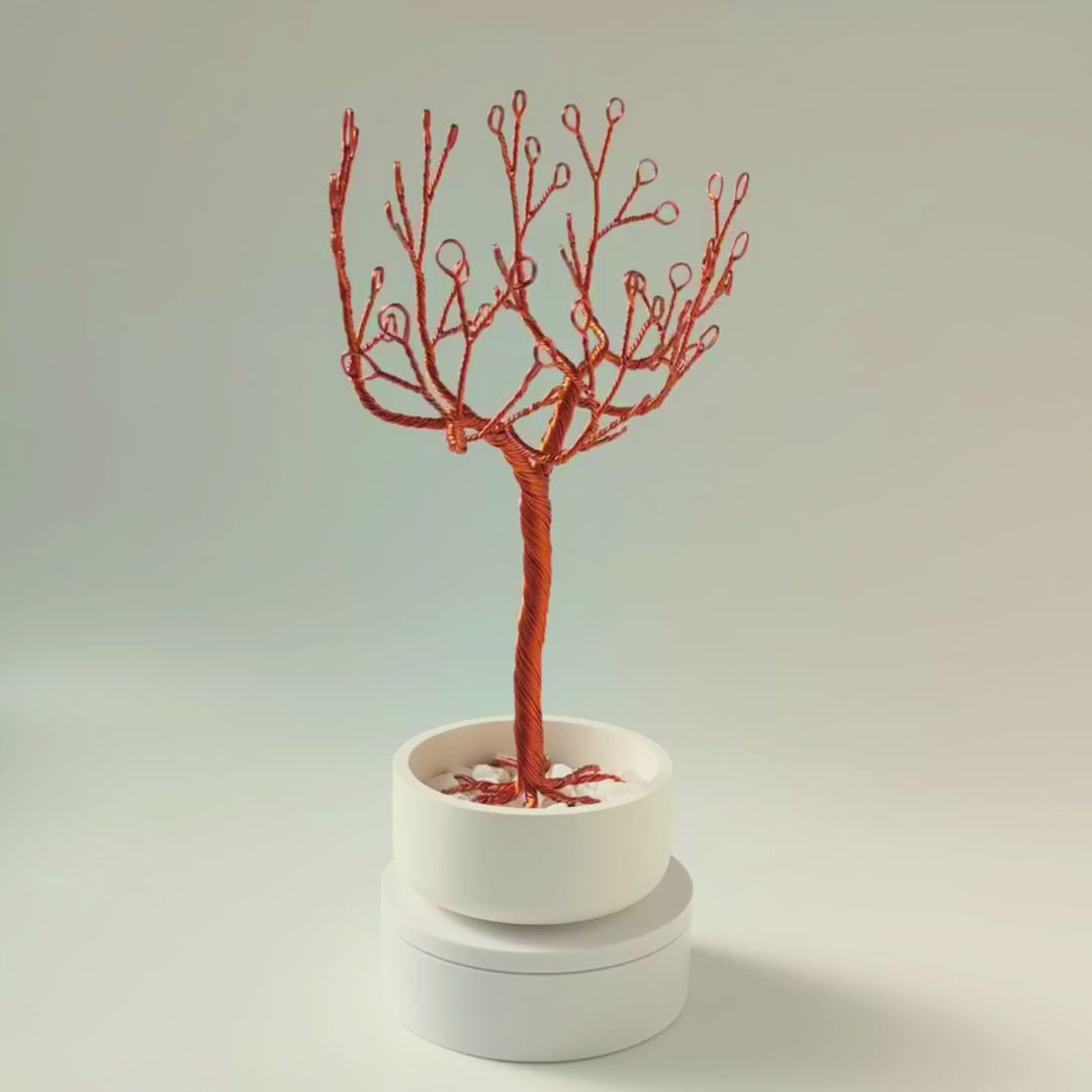 360° video of handmade copper jewelry tree with ceramic bowl and decorative white stones