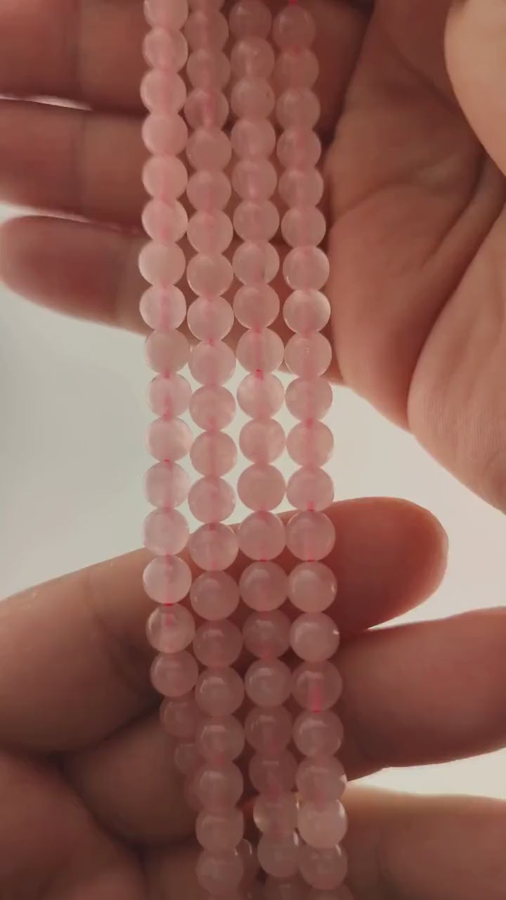 Video of strands of pale pink rose quartz spheres used for this tree, held in the hand