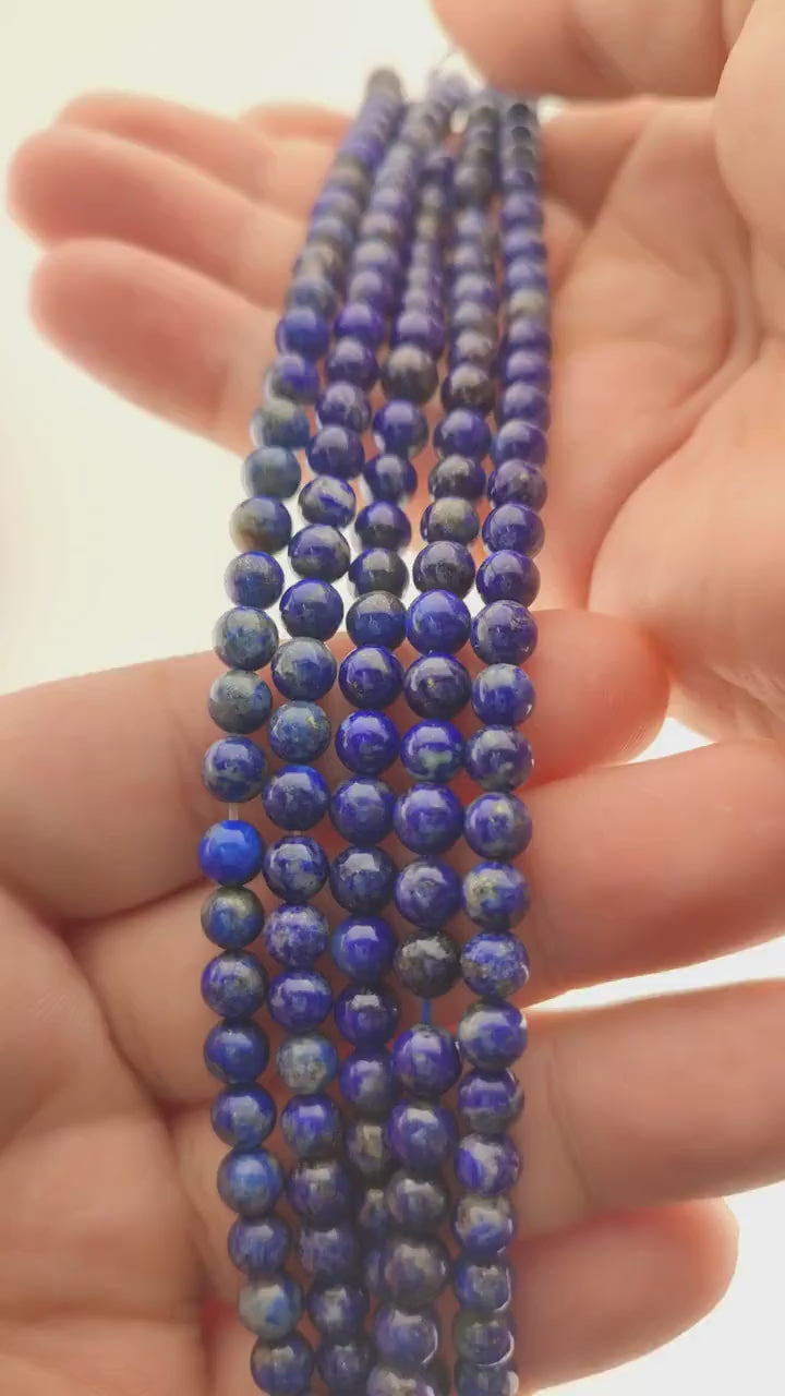 Video of strands of deep blue lapis lazuli beads used for this tree, held in the hand