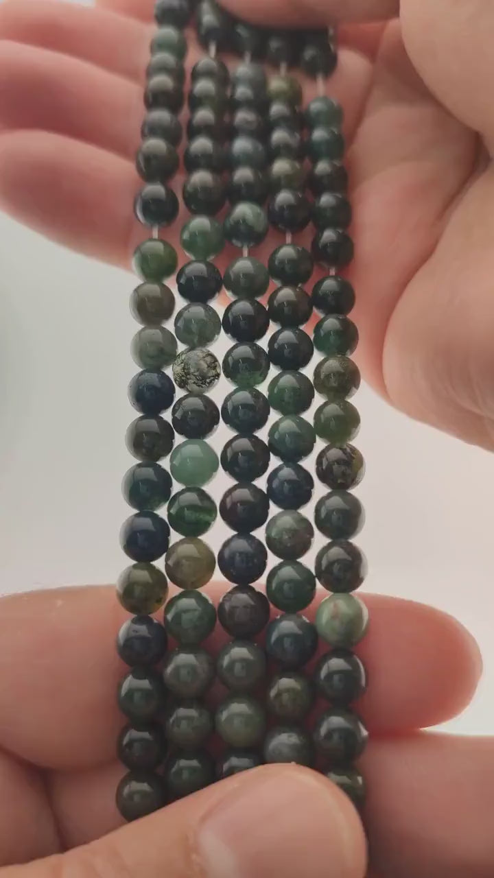 Video of strands of forest green moss agate spheres used for this tree, held in the hand