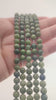 Video of strands of forest and sage green nephrite jade spheres used for this tree, held in the hand