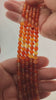 Video of strands of mixed red and orange carnelian spheres used for this tree, held in the hand