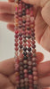 Video of strands of pink thulite beads used for this tree, held in the hand