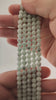 Video of strands of celadon green hemimorphite beads used for this tree, held in the hand