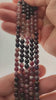 Video of strands of pink and green watermelon tourmaline beads used for this tree, held in the hand