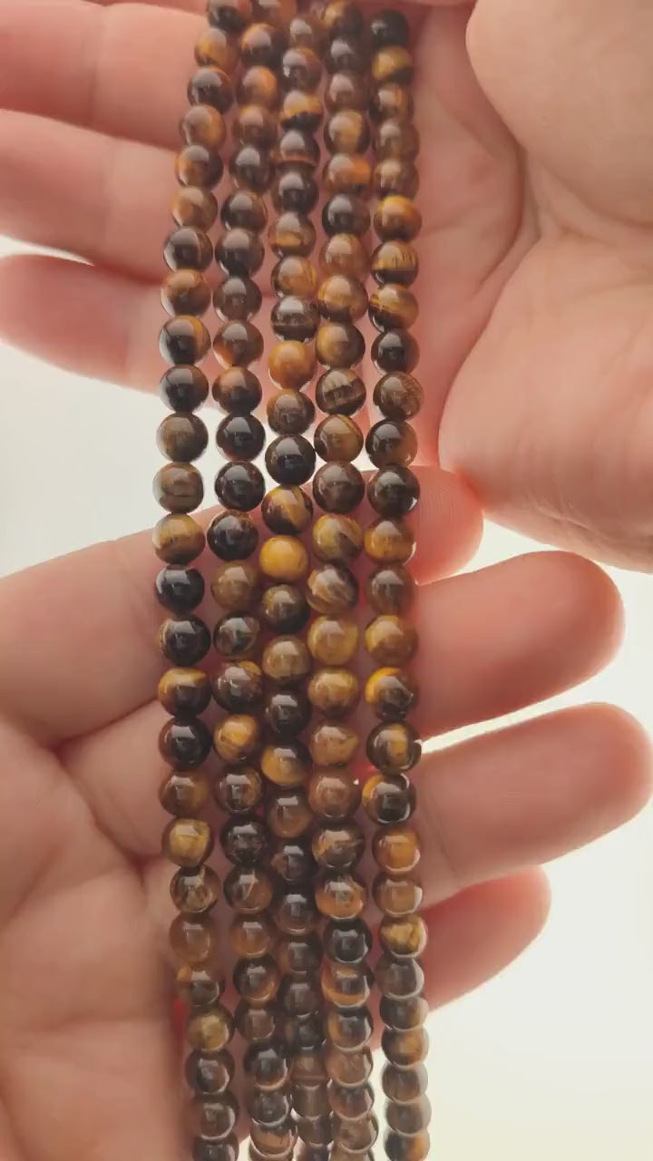 Video of strands of golden brown tiger's eye beads used for this tree, held in the hand