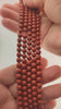 Video of strands of rich brick red jasper spheres used for this tree, held in the hand
