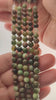 Video of strands of olive and rust green opal spheres used for this tree, held in the hand