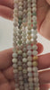 Video of strands of pale sea glass blue aquamarine spheres used for this tree, held in the hand