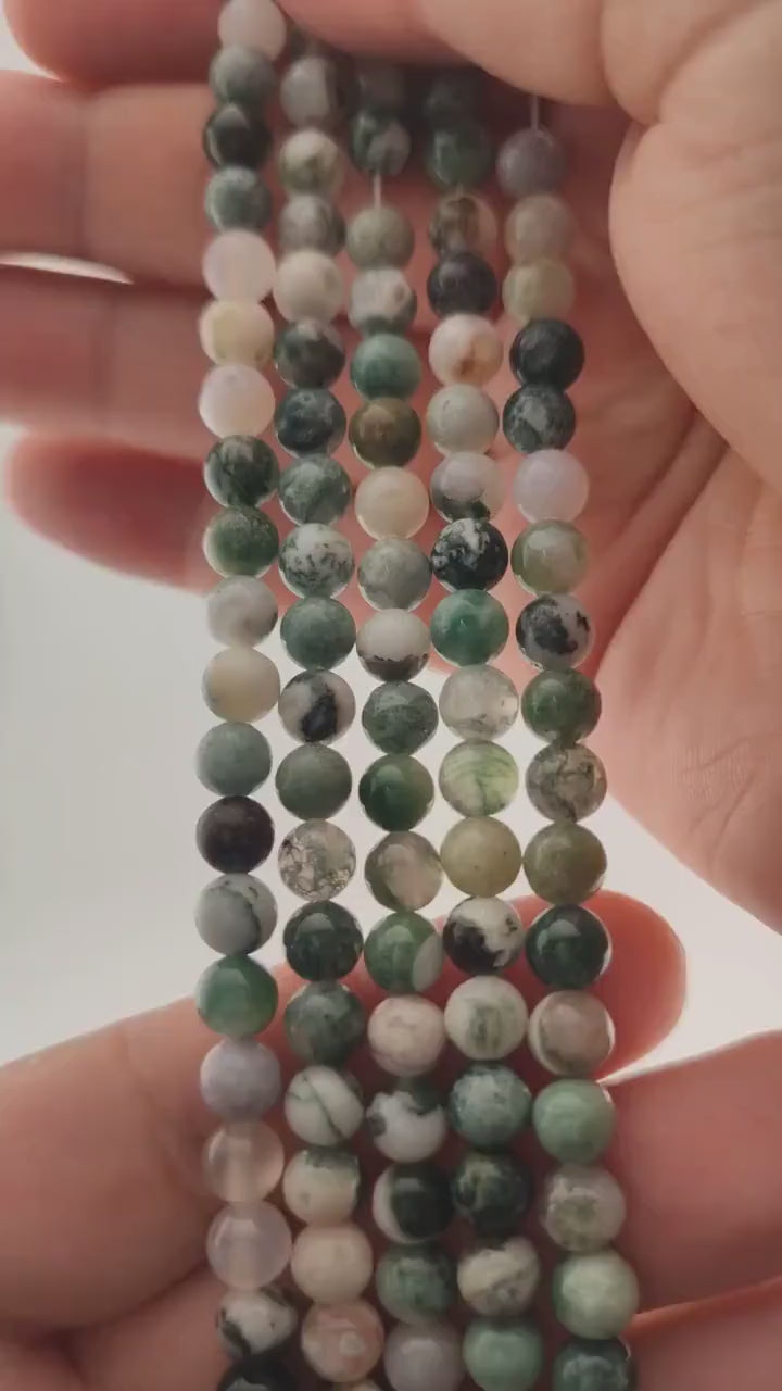 Video of strands of snowy white and fir green tree agate beads used for this tree, held in the hand