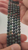 Video of strands of deep forest green moss agate beads used for this tree, held in the hand