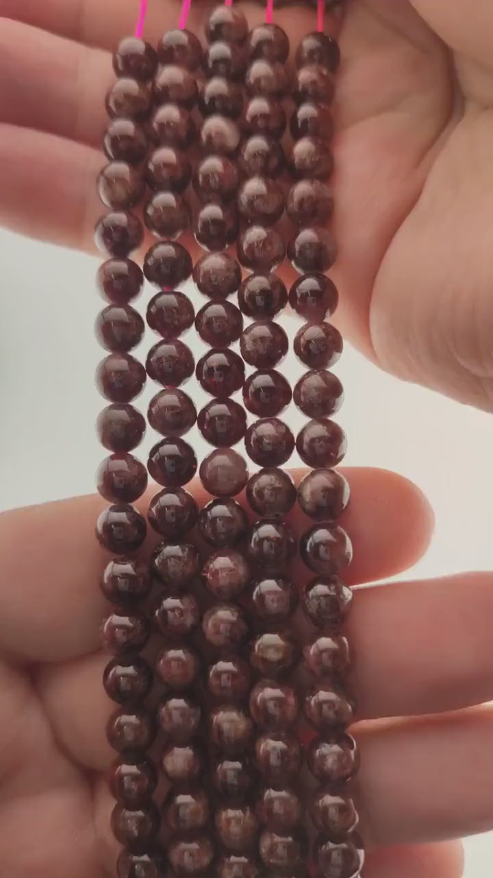 Video of strands of black cherry red garnet beads used for this tree, held in the hand