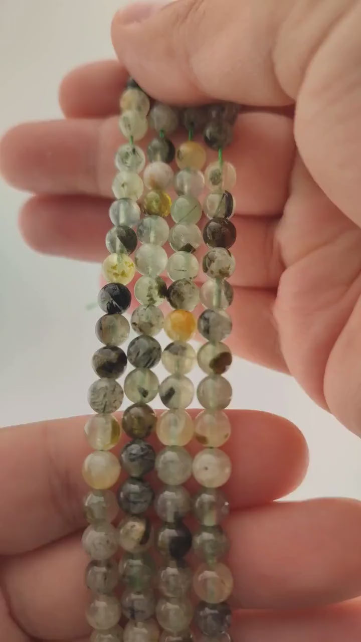 Video of strands of green prehnite beads used for this tree, held in the hand