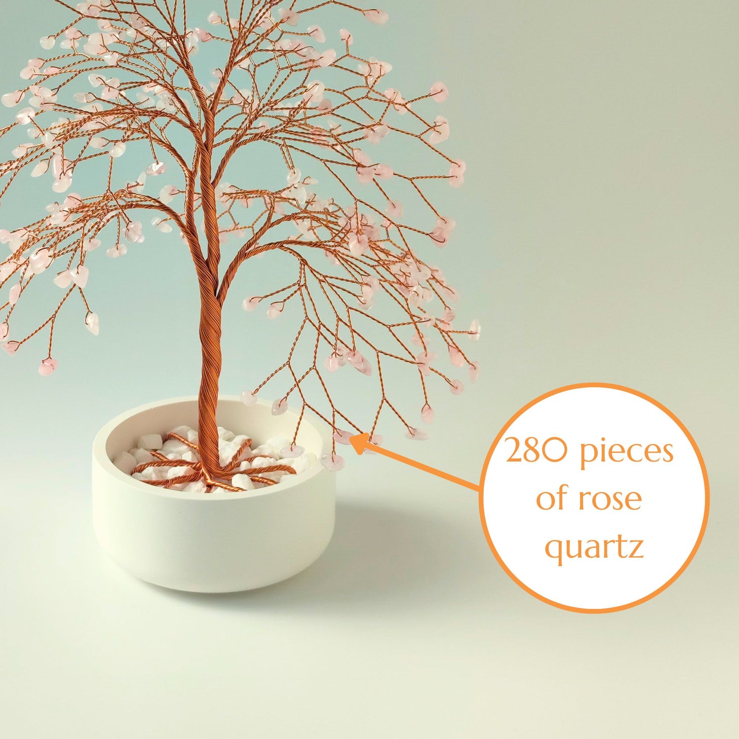 Close-up of copper wire branch with 280 natural rose quartz gemstone – elegant detail