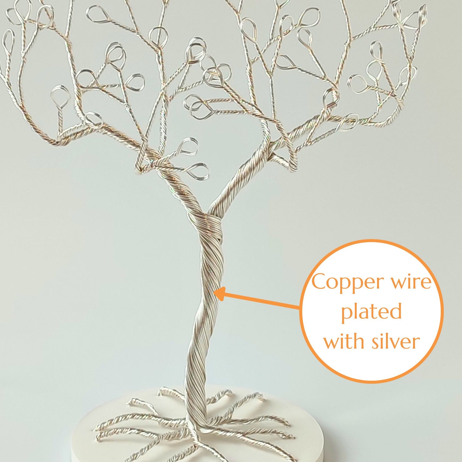 Close-up of silver plated wire jewelry stand trunk with material annotation and tray