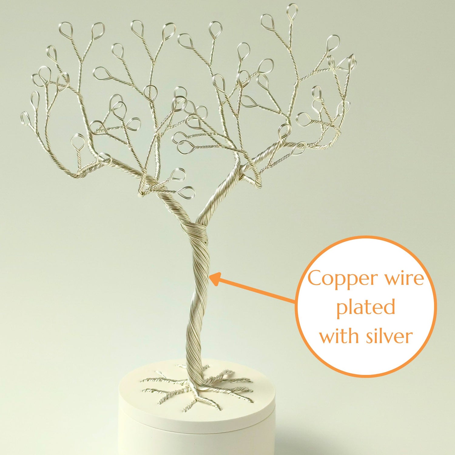Close-up of silver plated wire jewelry stand trunk with material annotation
